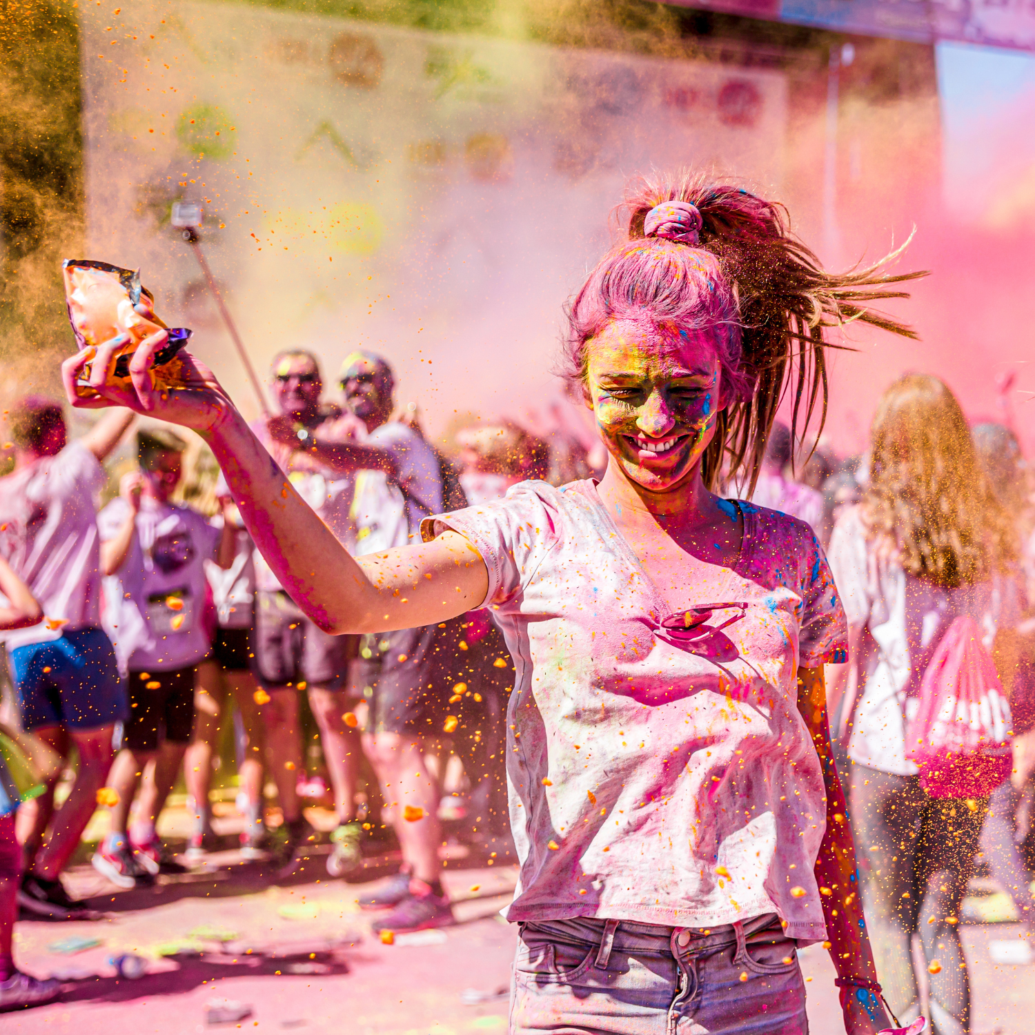 Color walk run in action with a girl splashed in vibrant pink color powder