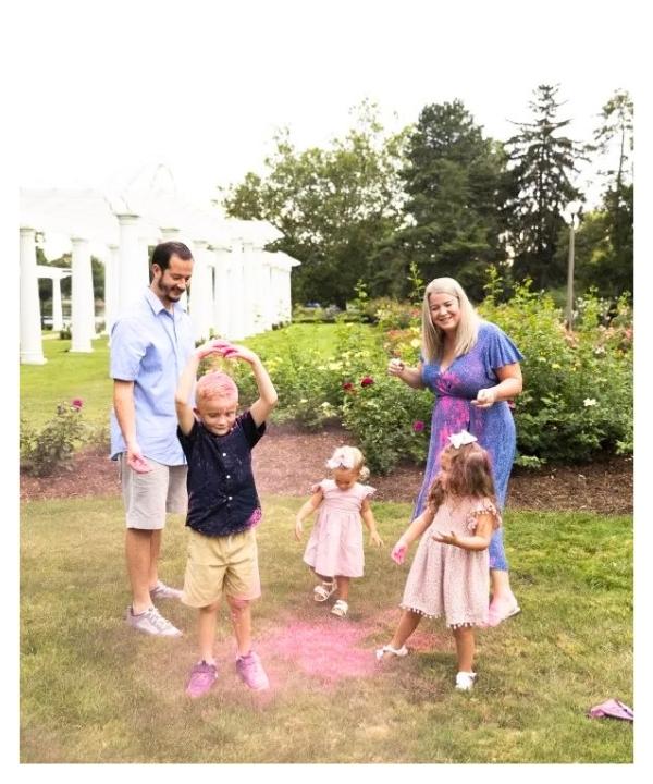 Family playing with color powder in a backyard