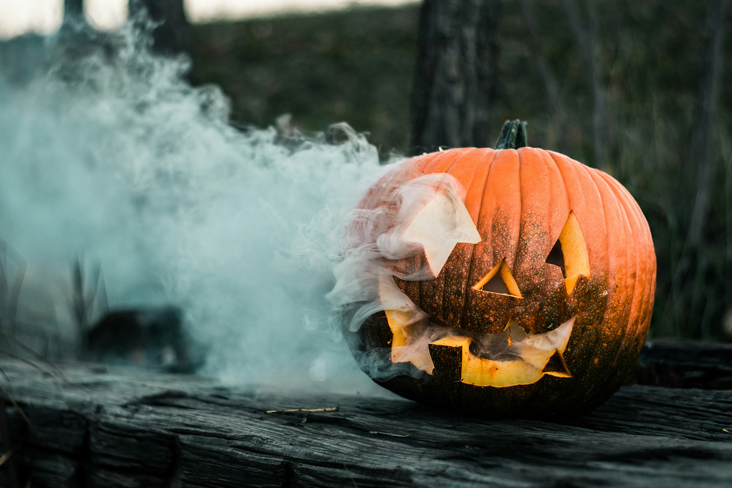 Carved jack-o'-lantern with a cloud of smoke